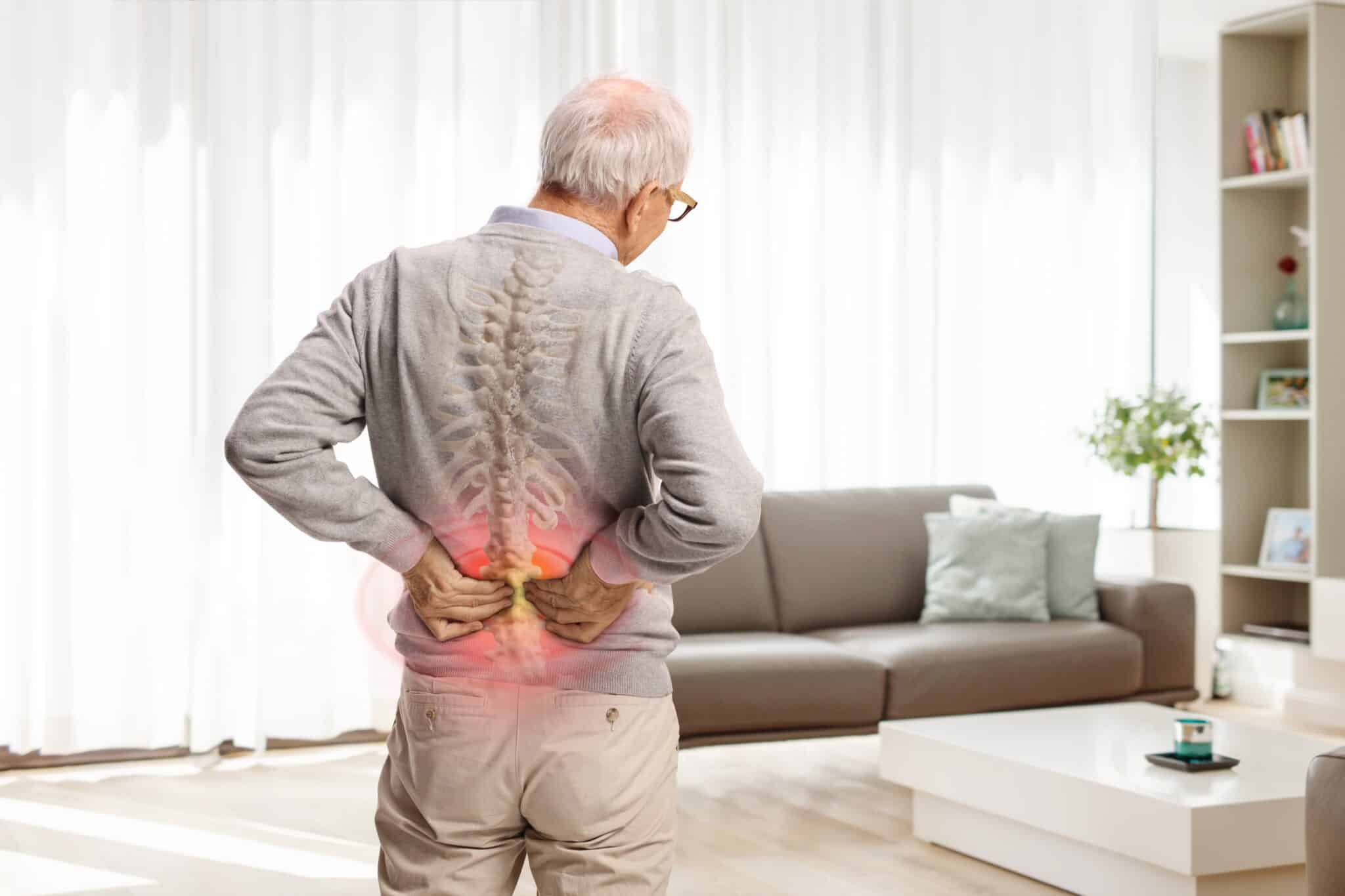 rear,view,shot,of,an,elderly,man,in,pain,holding