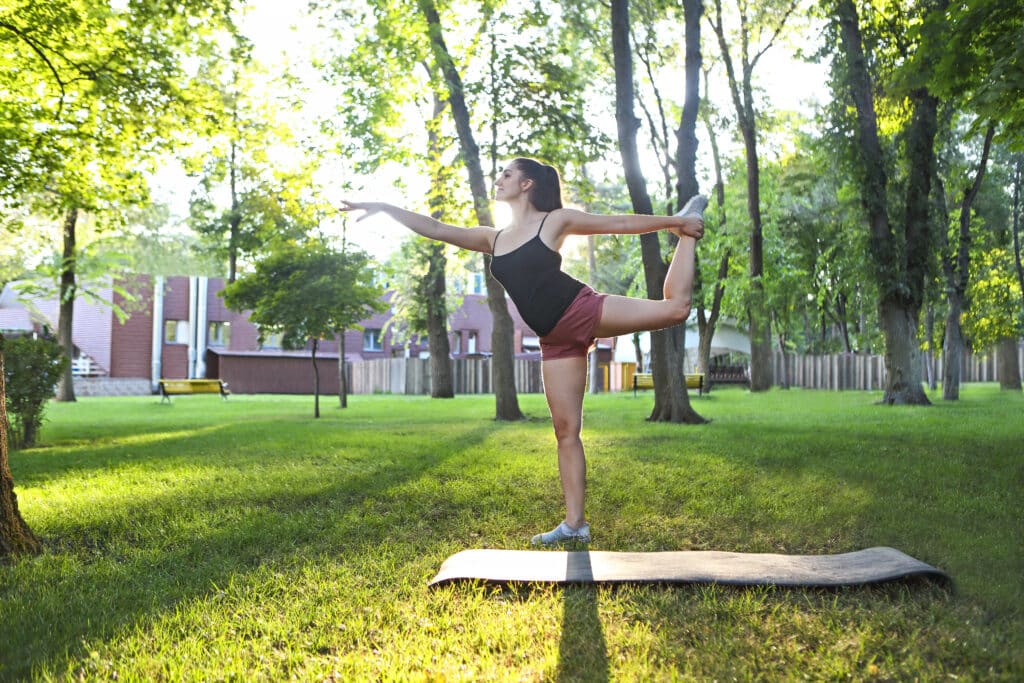 stretching woman in outdoor exercise smiling happy doing stretch