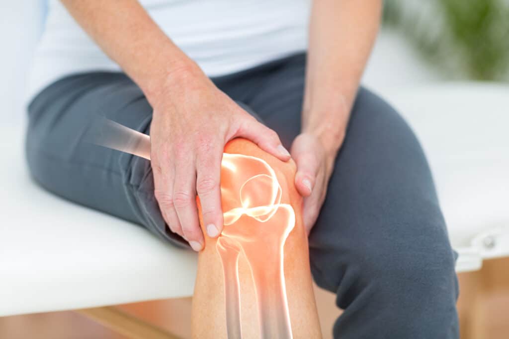 woman holding knee with bone overlay 2026 03 26 11 49 19 utc
