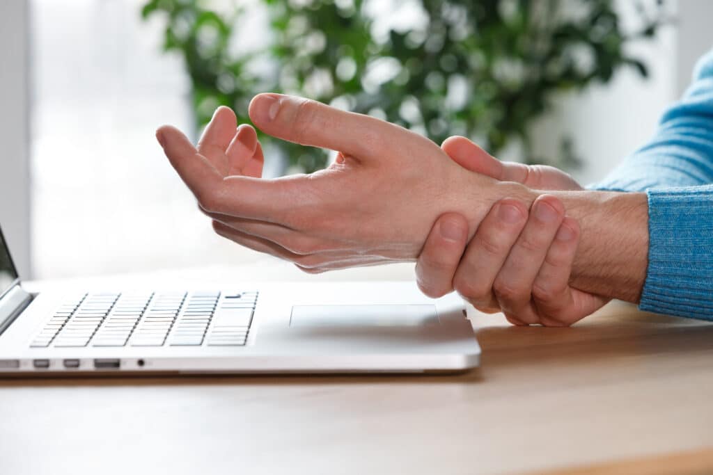 carpal tunnel syndrome. man arms holding his painful wrist