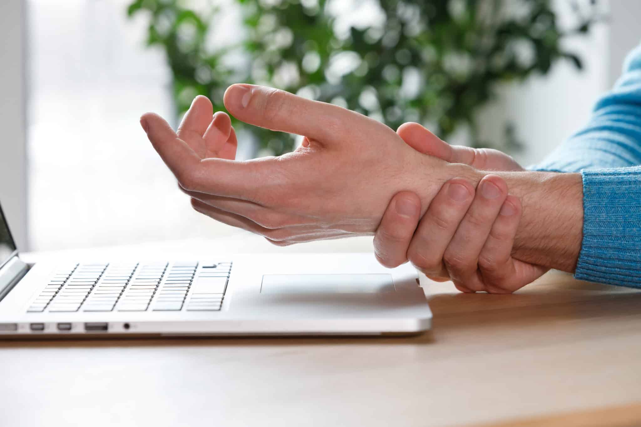 carpal tunnel syndrome. man arms holding his painful wrist
