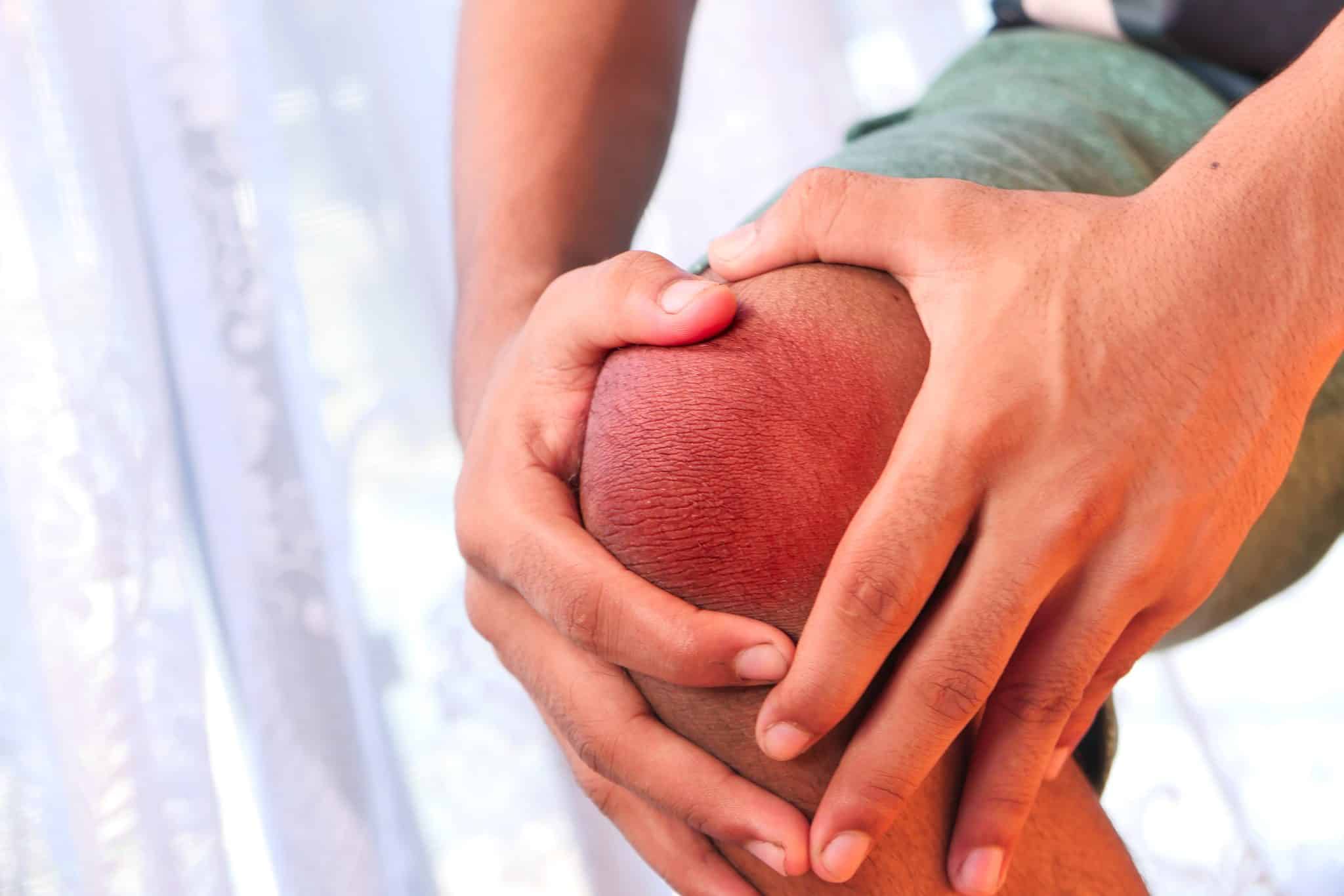 close up on man suffering knee joint pain